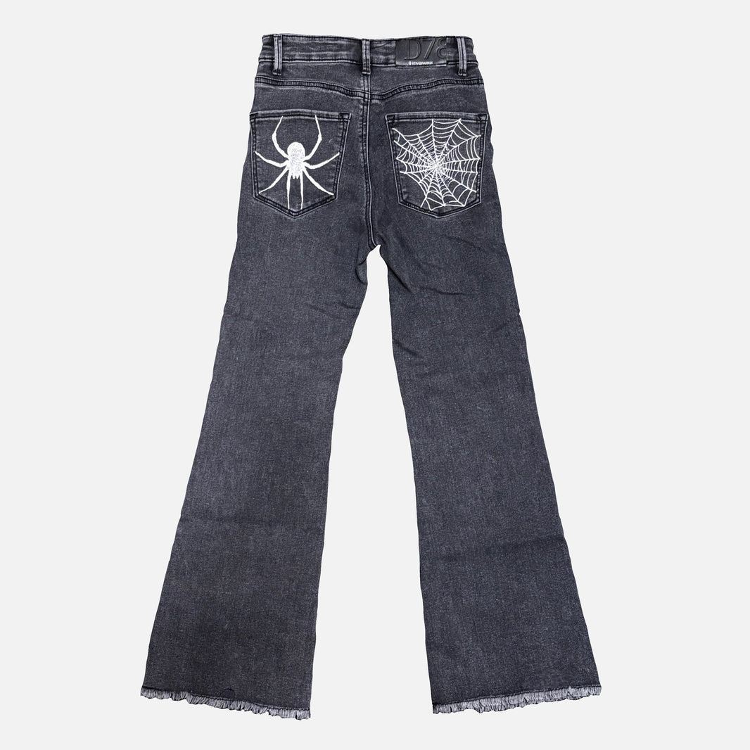 Dark gray denim jeans shown from the back, featuring a white spider graphic on the right back pocket and a white spiderweb design on the left back pocket, with frayed hems.