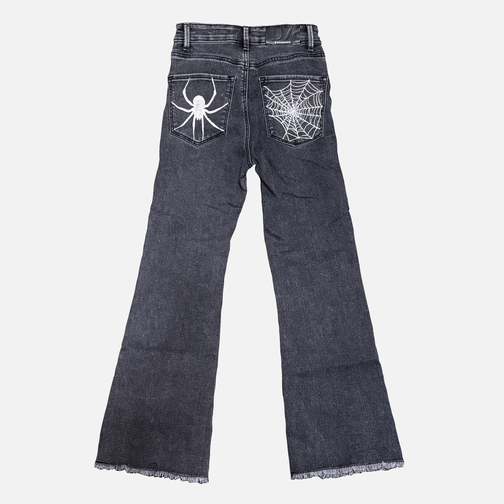 Dark gray denim jeans shown from the back, featuring a white spider graphic on the right back pocket and a white spiderweb design on the left back pocket, with frayed hems.